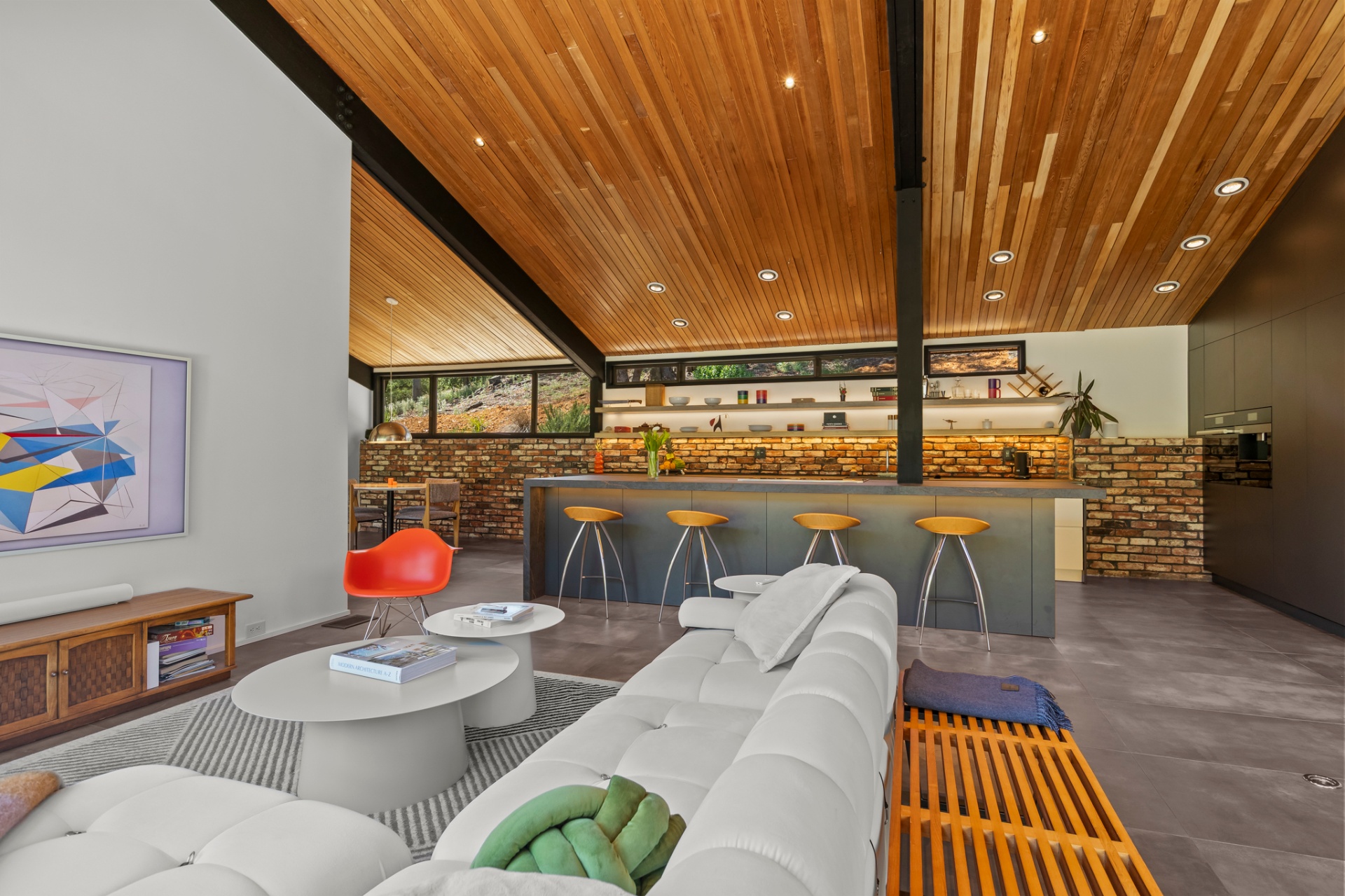 Living room with sectional sofa, bar seating and a brick accent wall