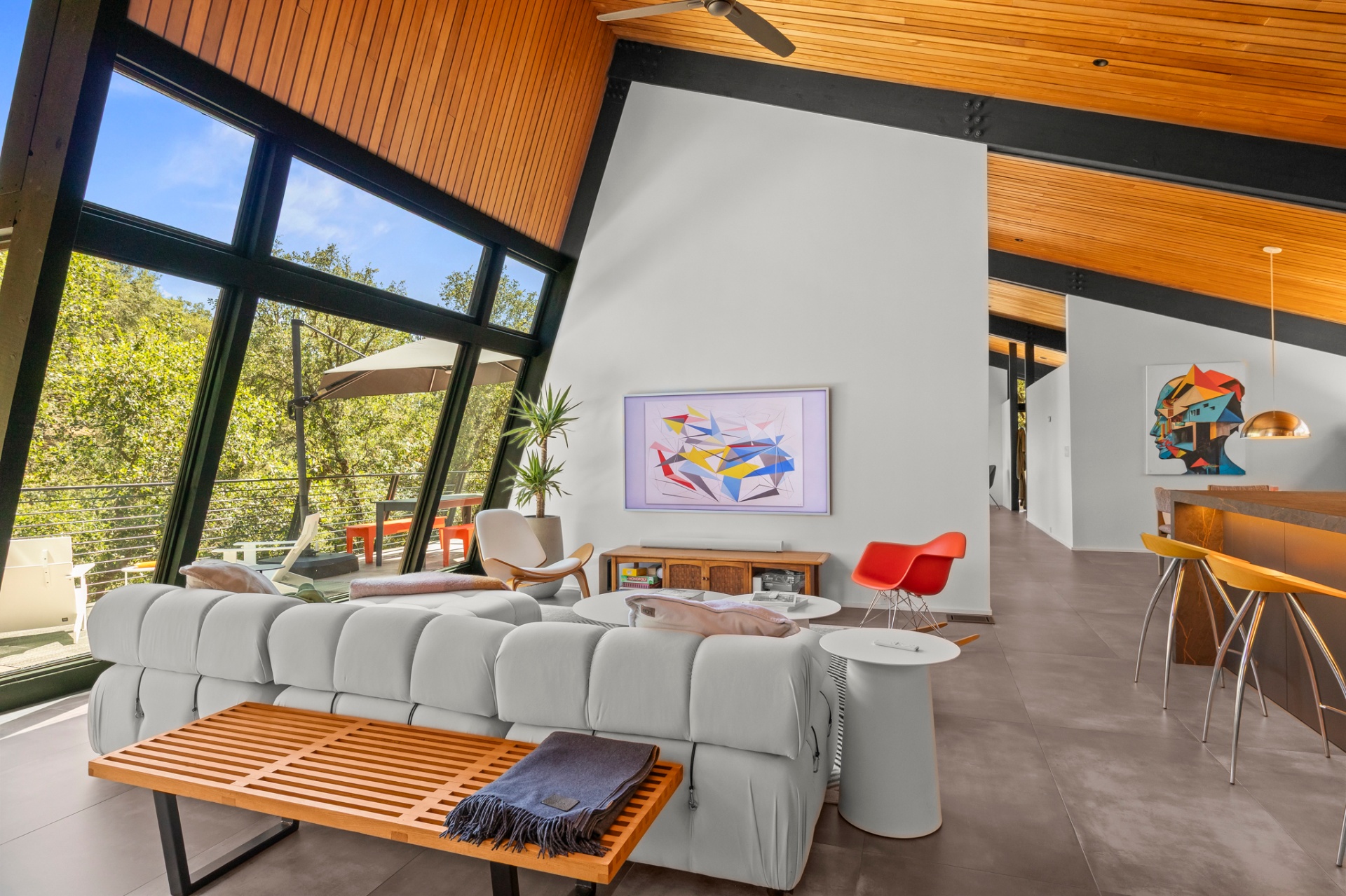 Lounge with tufted white sectional, abstract art and clerestory windows