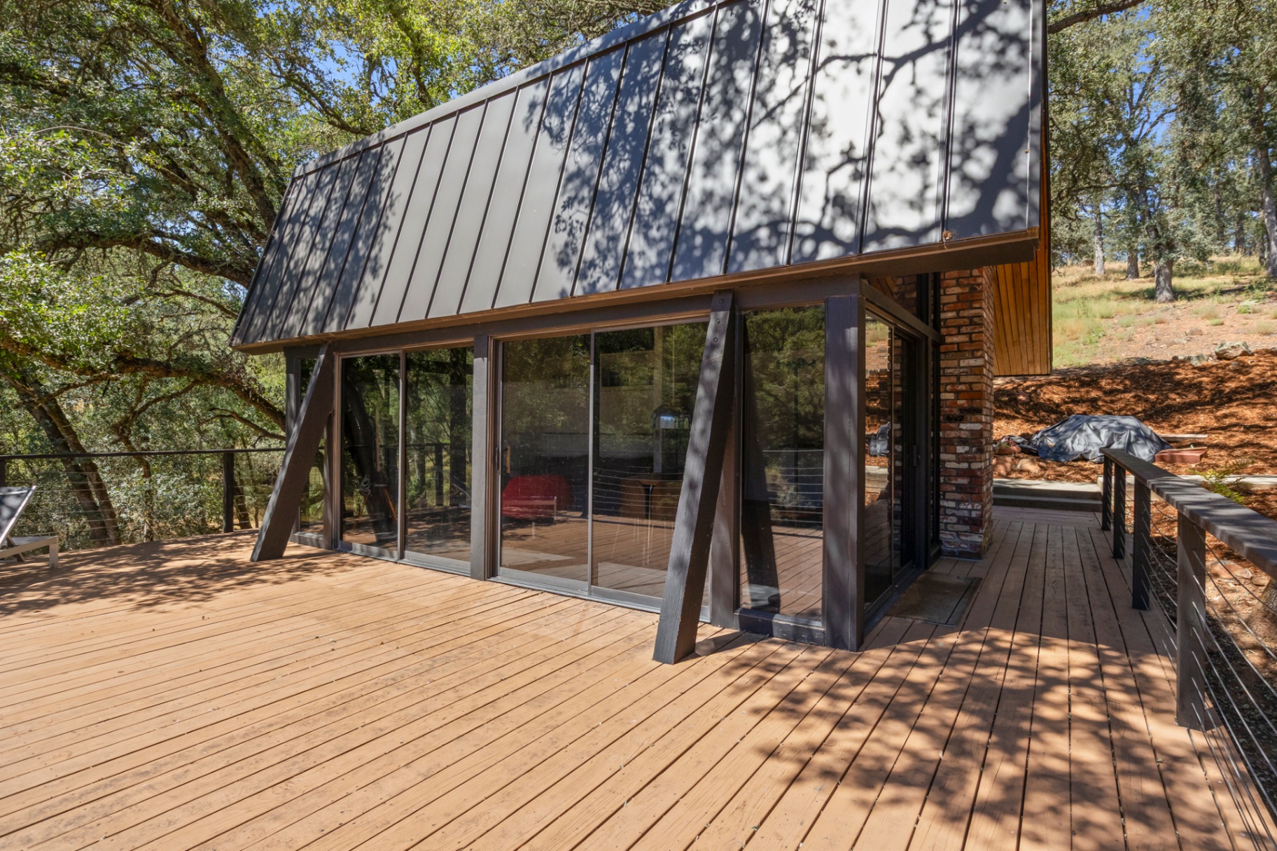 Lower deck with metal-roof overhang and glass walls