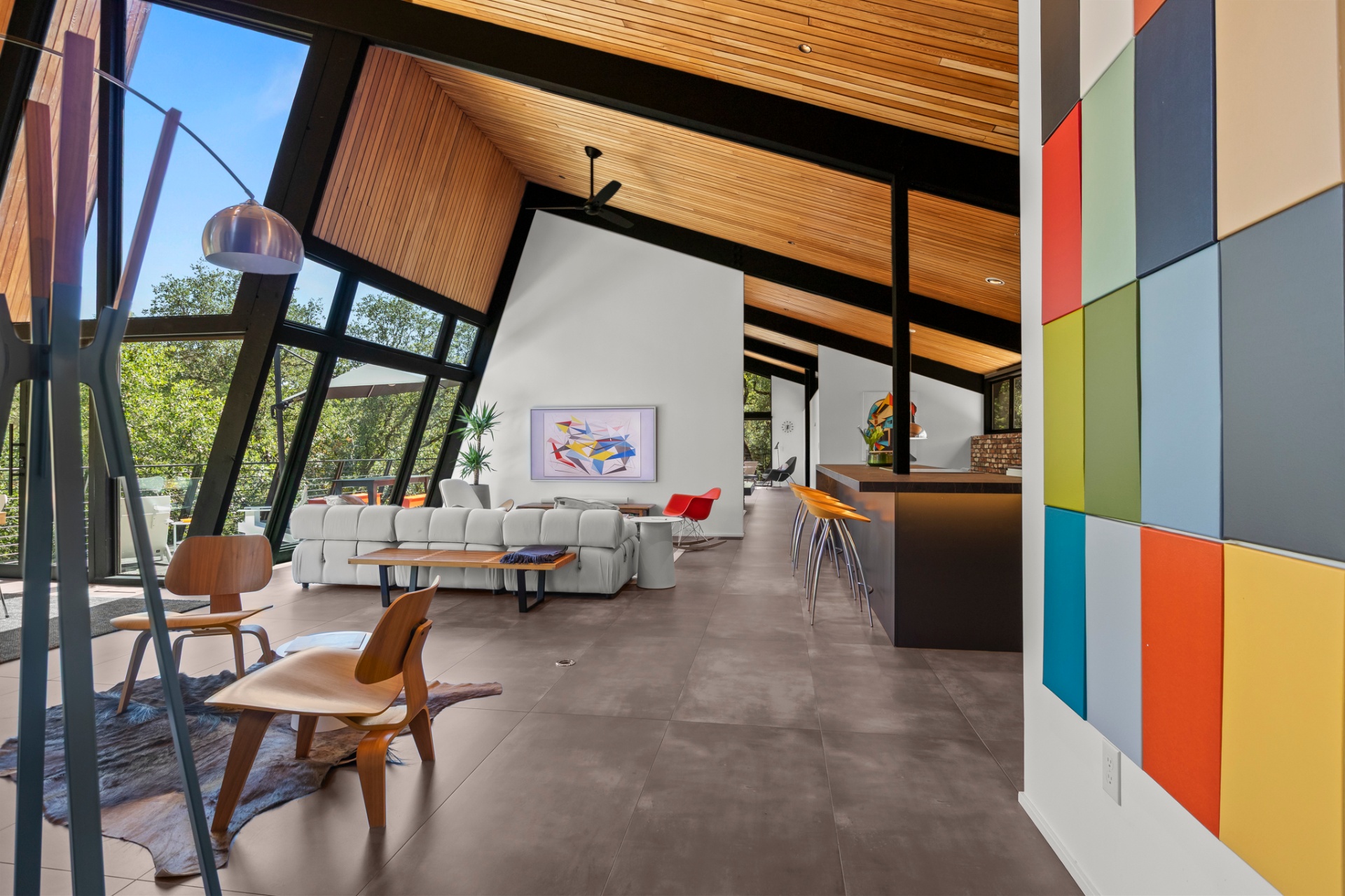 Lounge with vaulted wood ceiling and color-block accent wall